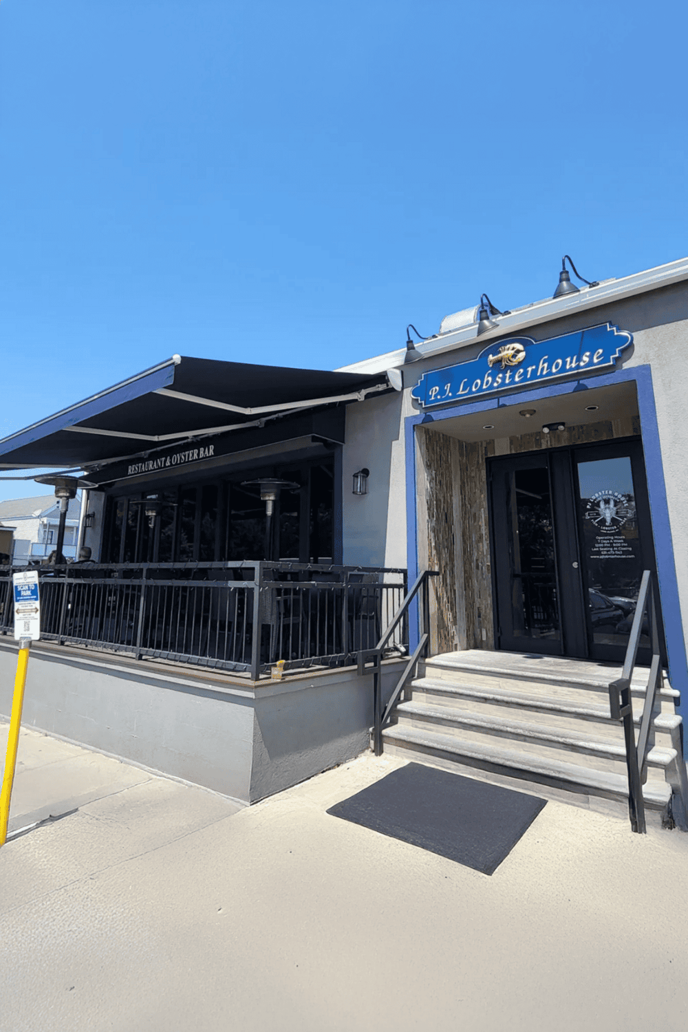 Seafood restaurant exterior, P. J. Lobsterhouse with outdoor seating, ocean-inspired decor, popular for lobster dishes.