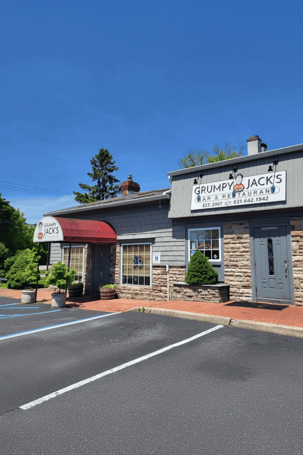 Quiet neighborhood restaurant with brick accents and outdoor seating, welcoming atmosphere, perfect for casual dining.