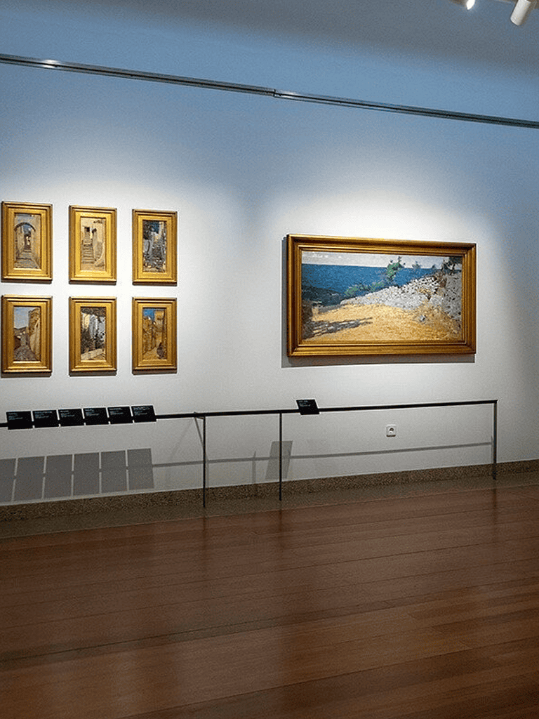 Colorful landscape paintings displayed in an art gallery.