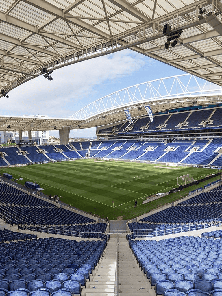 Spacious soccer stadium with modern architecture and lush green field, ready for a match.