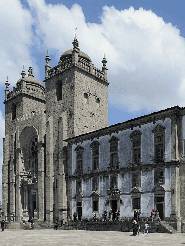 Historic colonial architecture with twin towers overlooking a lively public square in Quito, Ecuador.