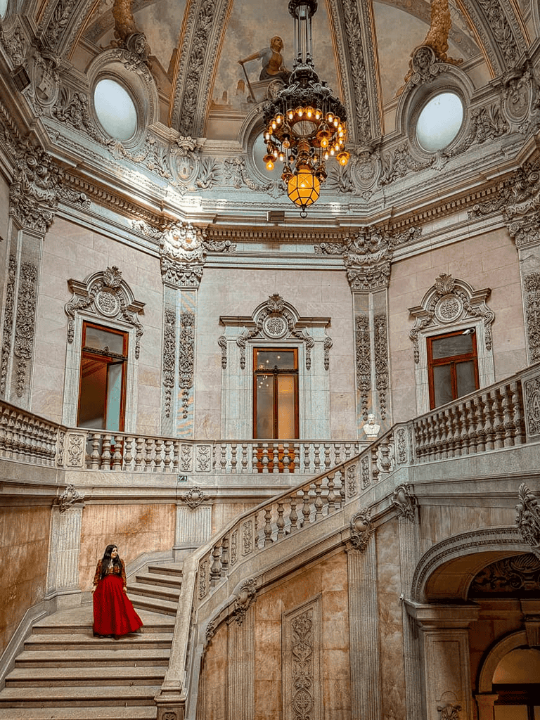 Luxurious historic interior with ornate architectural details and grand staircase.