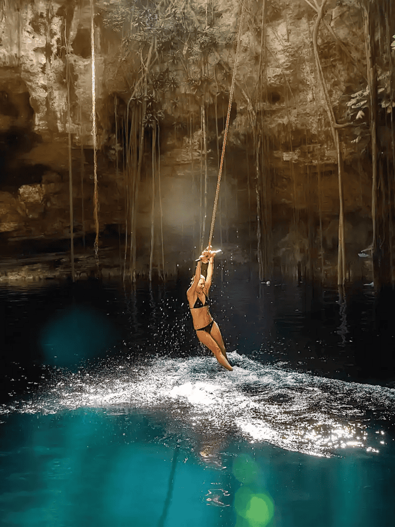Jumping into a clear blue cenote in Mexico, adventure and nature travel at its best.