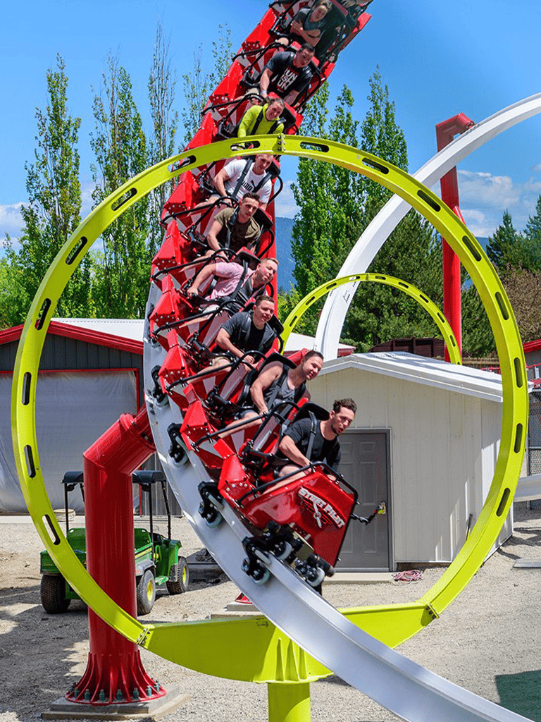 Thrilling roller coaster ride at QuestForDirections amusement park on a sunny day.