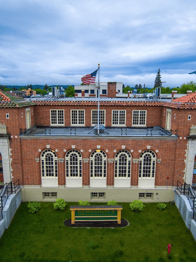 Historic brick building with American flag and greenery, part of QuestForDirections location.