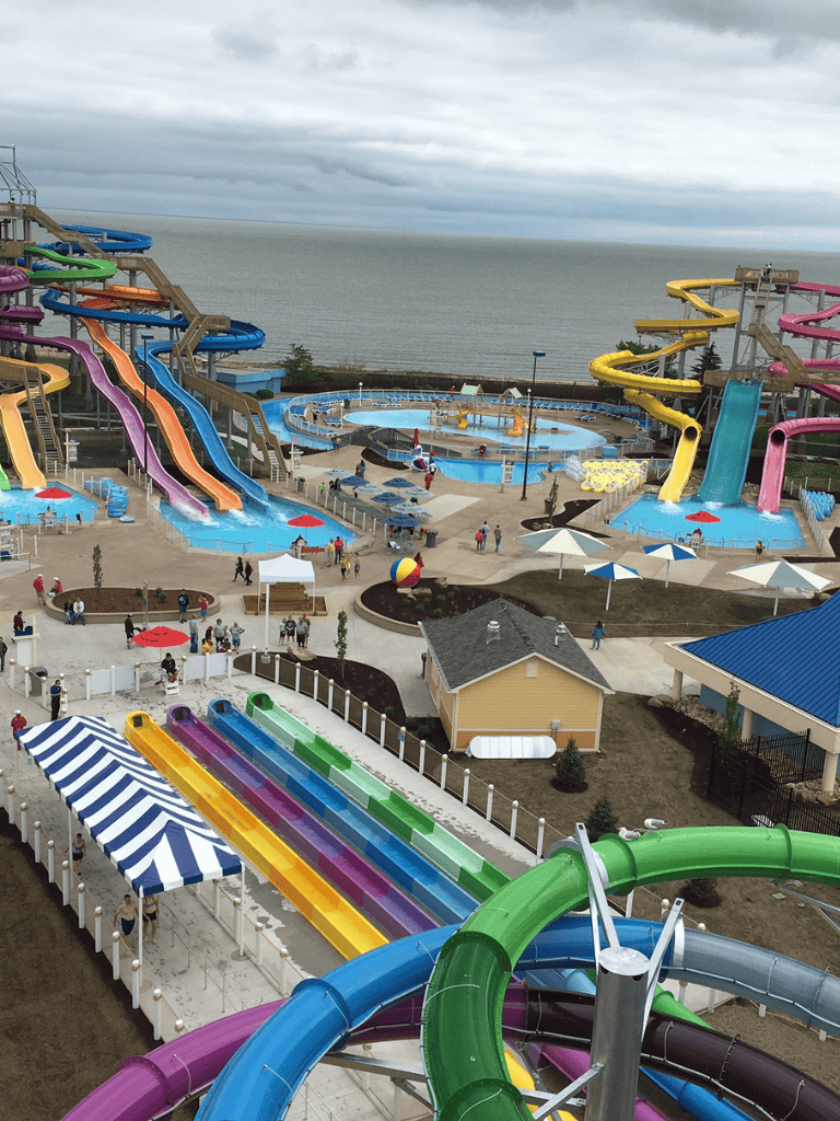 Colorful water slides and pools at a water park near the ocean, ideal for family fun and water activities.