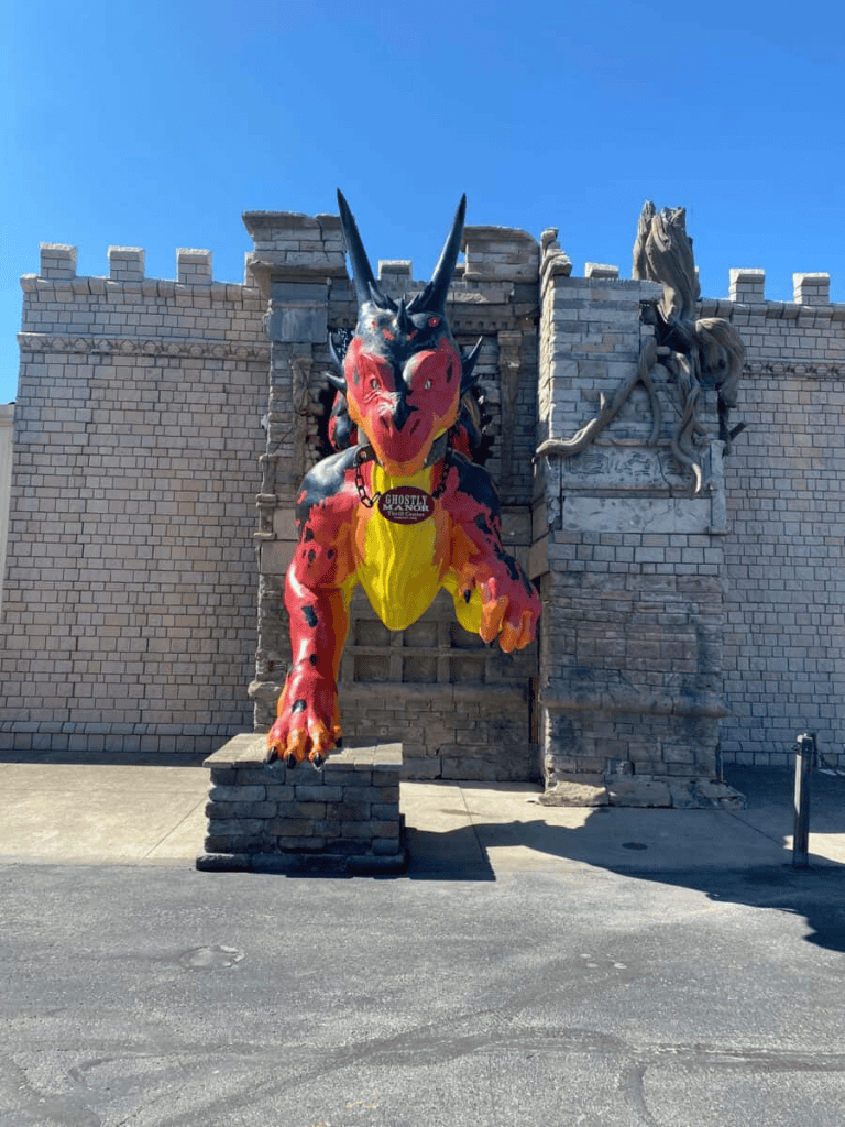 Colorful dragon statue at QuestForDirections attraction, showcasing a fantasy-themed maze experience.