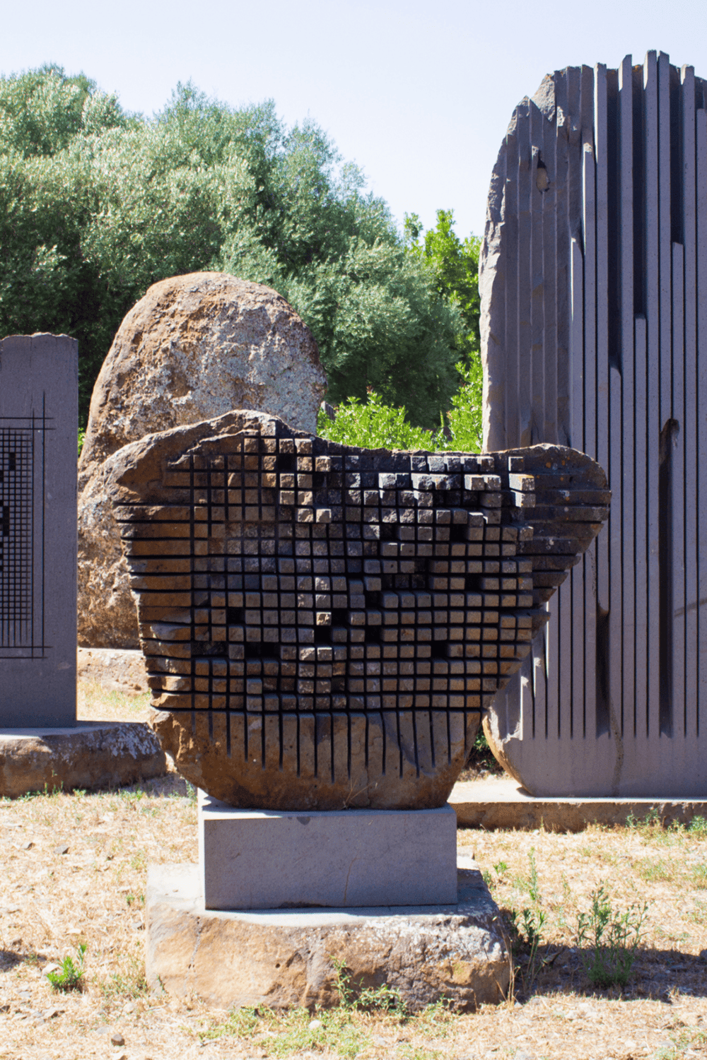 Colorful abstract outdoor sculpture made of stone and metal, part of QuestForDirections art exhibit.
