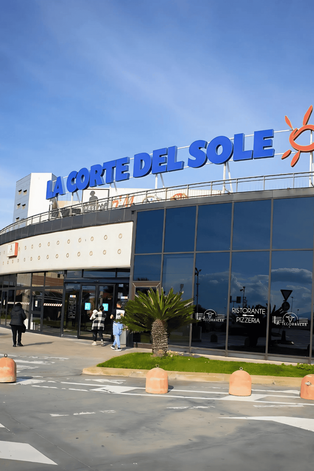 Shopping center La Corte del Sole with dining options and modern architecture.