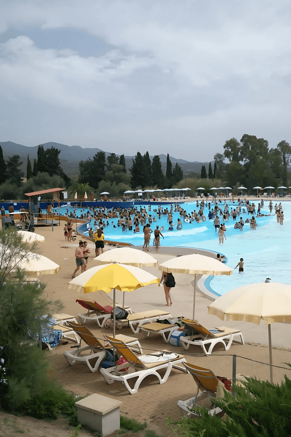 Relaxing poolside at QuestForDirections resort with umbrellas and scenic mountain views.