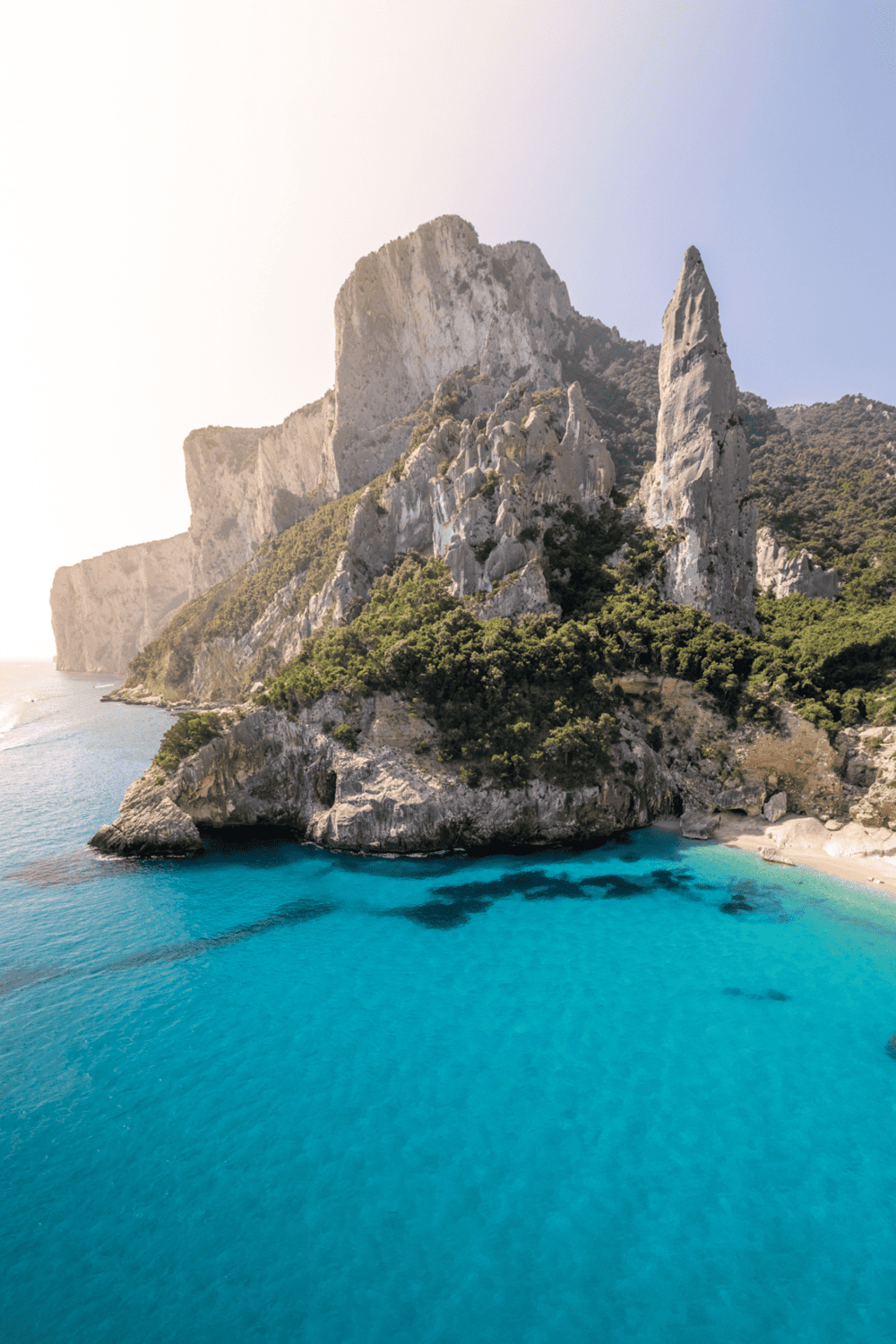 Stunning coastal cliffs with turquoise waters on a sunny day, perfect for travel and adventure.