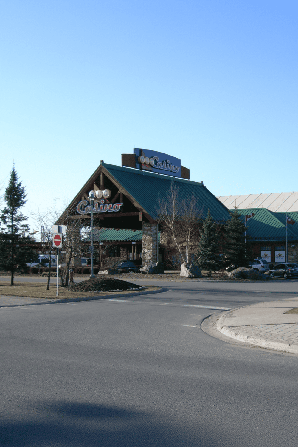 Casino resort in a scenic mountain setting with trees and clear skies.
