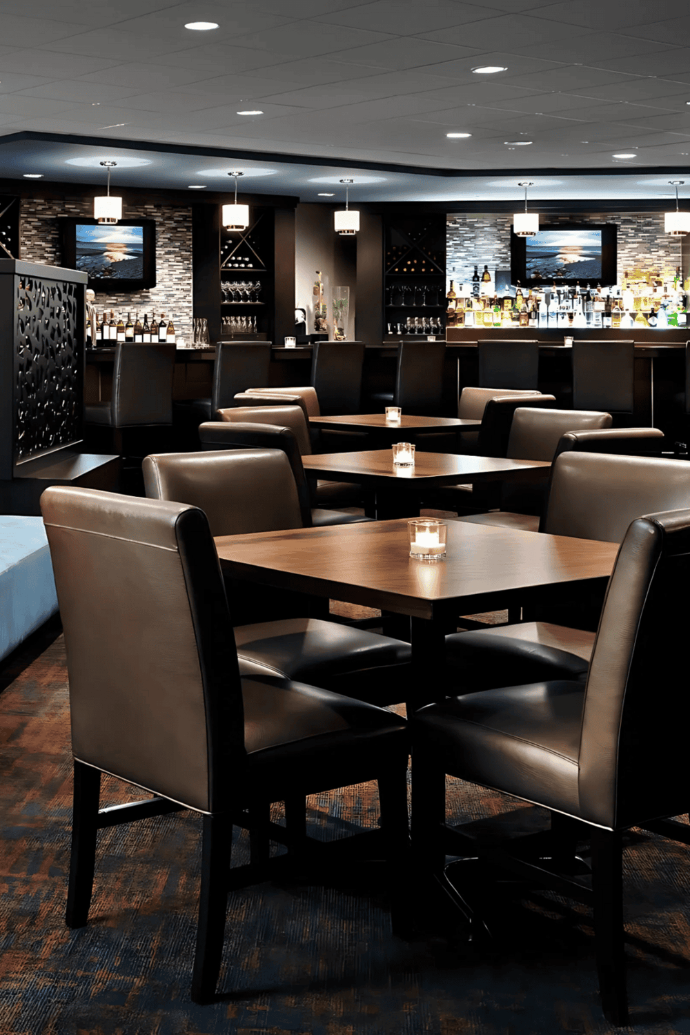 Elegant bar and lounge with modern decor, cozy seating, and a fully stocked drink selection.