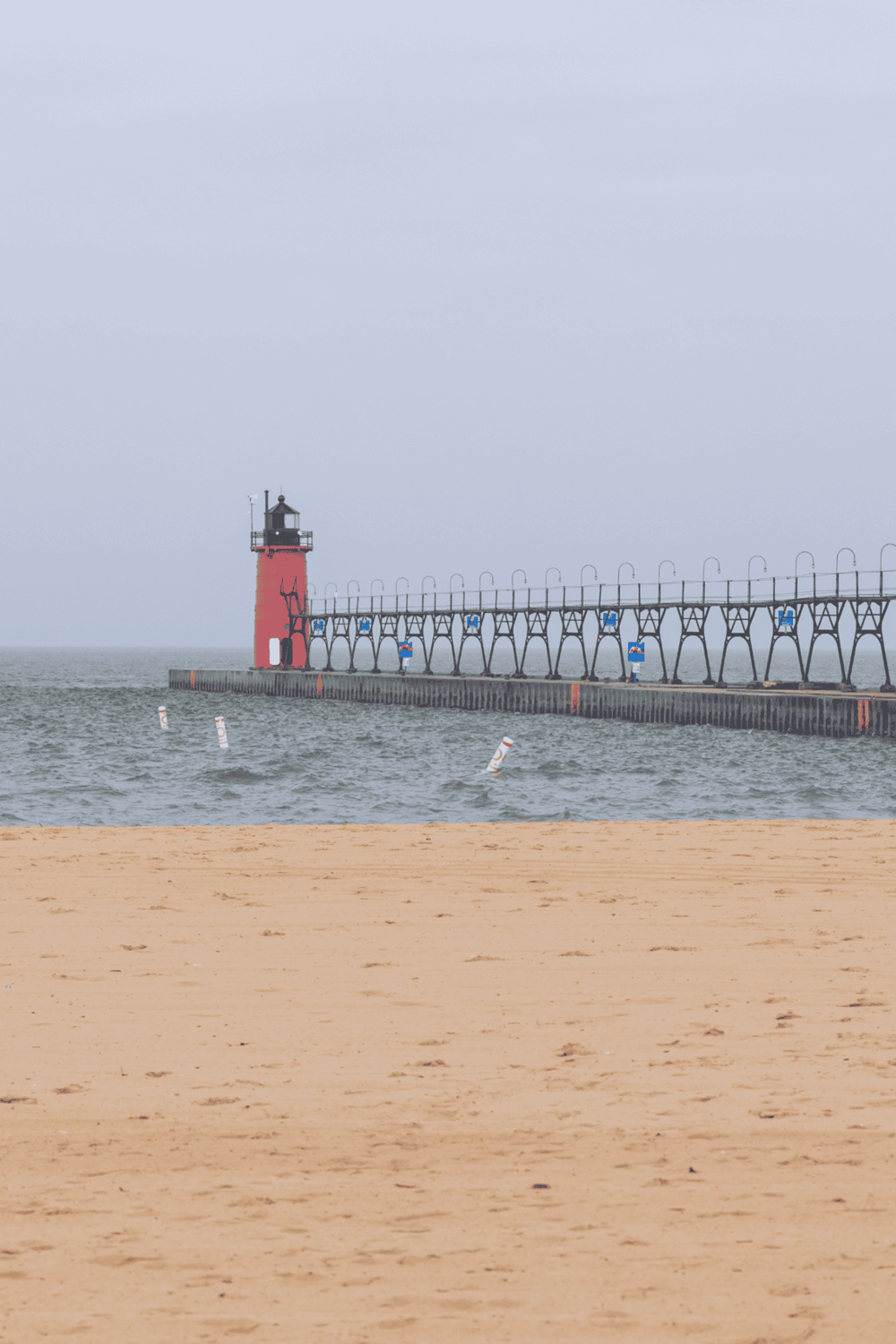 Lighthouse at Saint Joseph Michigan on Lake Michigan with pier and beach, scenic coastal navigation guide.
