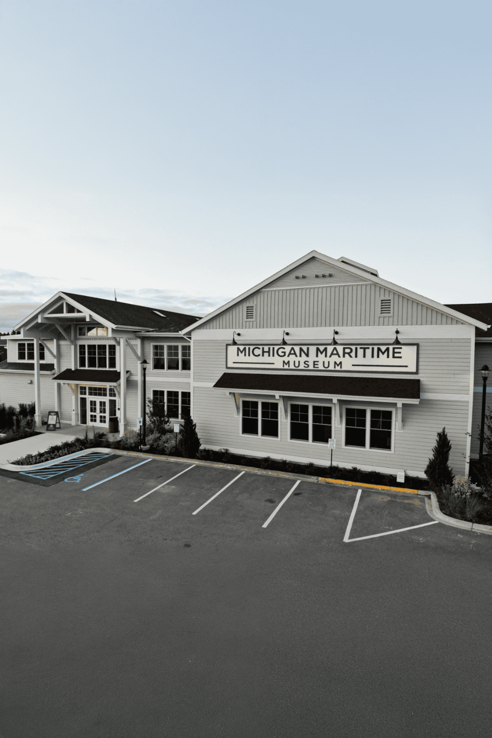Quiet, modern Michigan Maritime Museum building with parking lot, showcasing local maritime history.