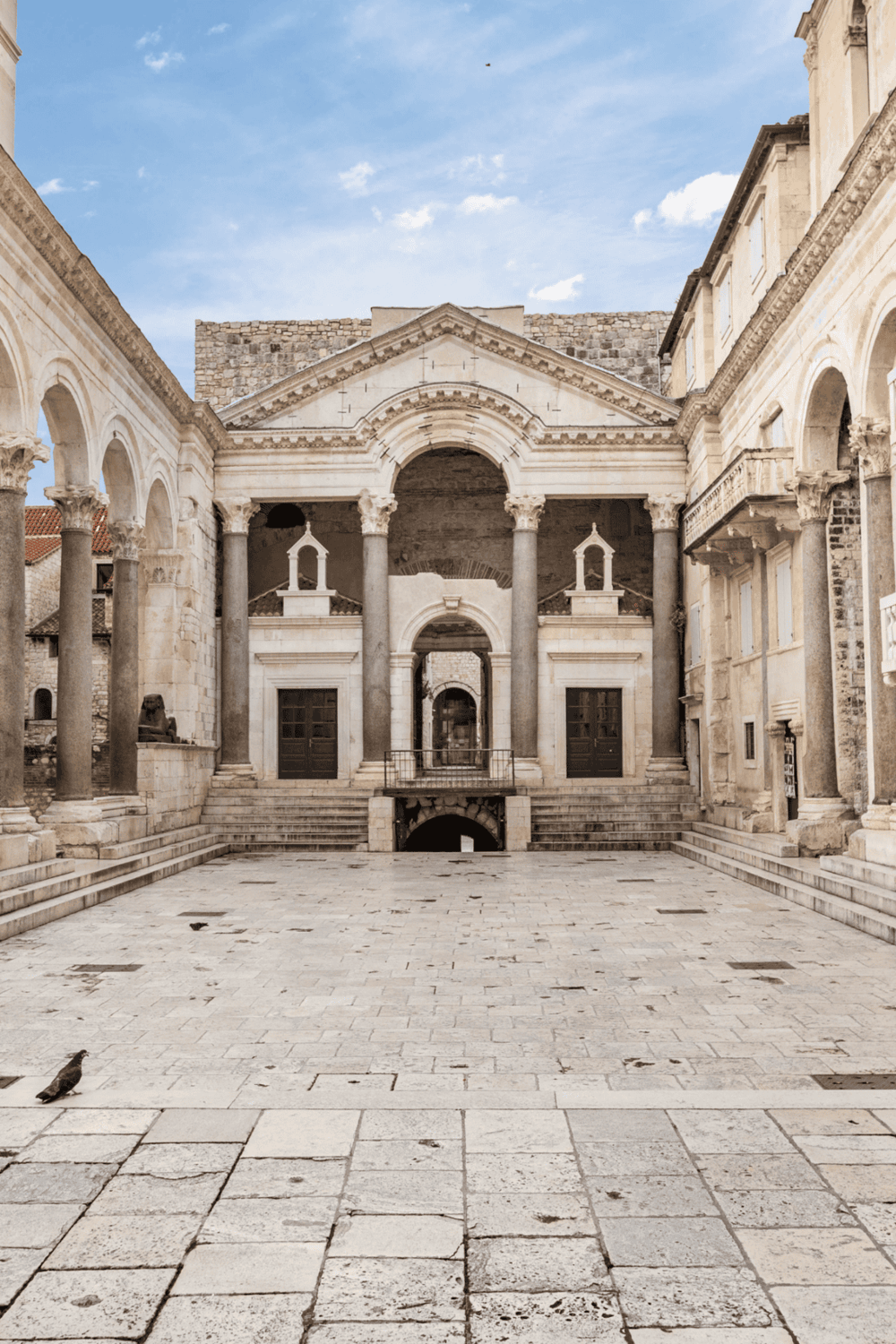 Ancient Roman-style architecture at QuestForDirections, historic site with columns and stone buildings.