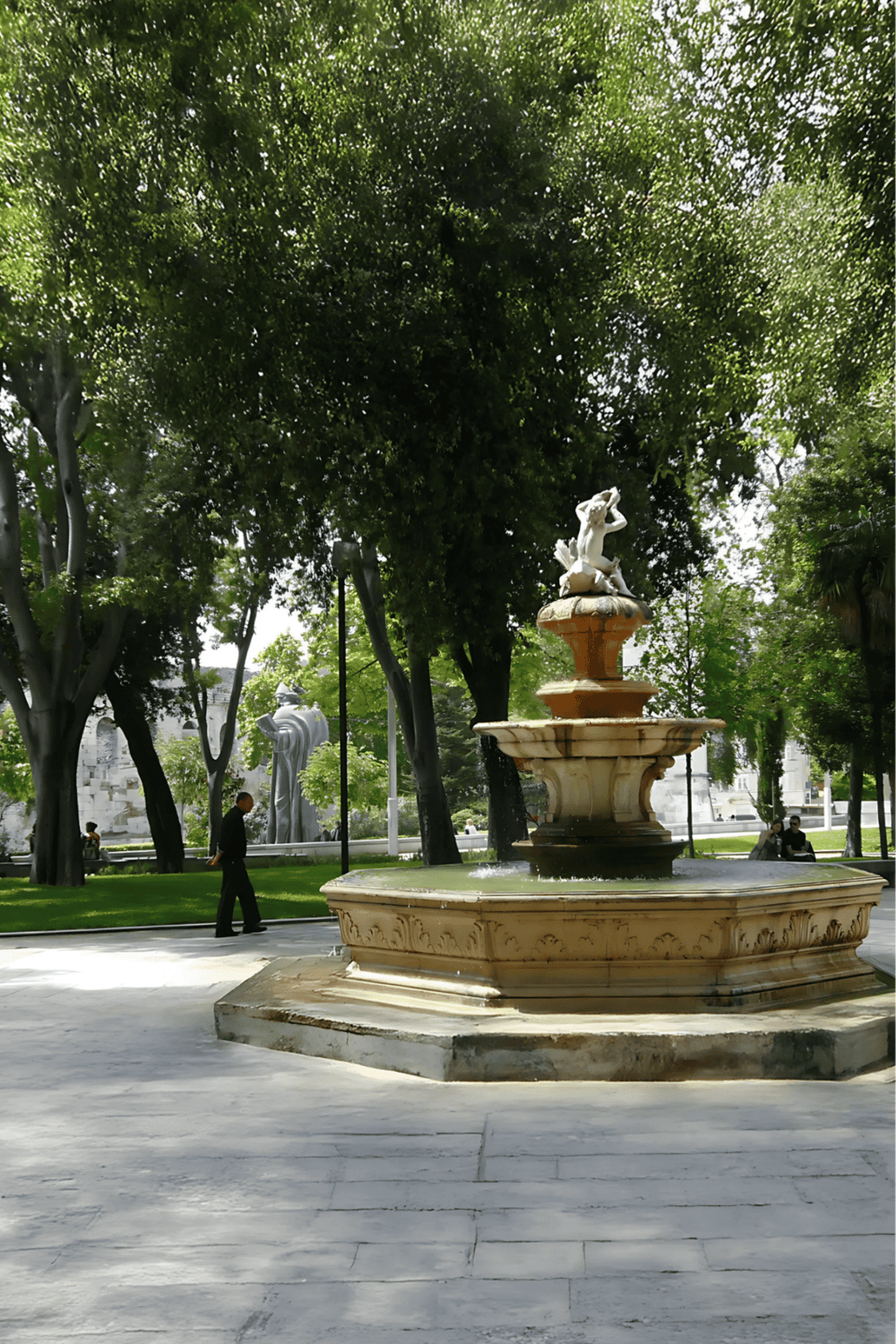 Elegant marble fountain in a serene park setting, perfect for community gatherings and relaxation.