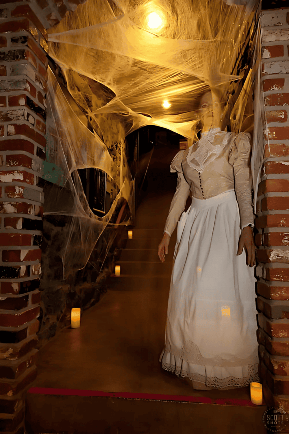1. Haunted house hallway with cobwebs and eerie lighting for Halloween decor.