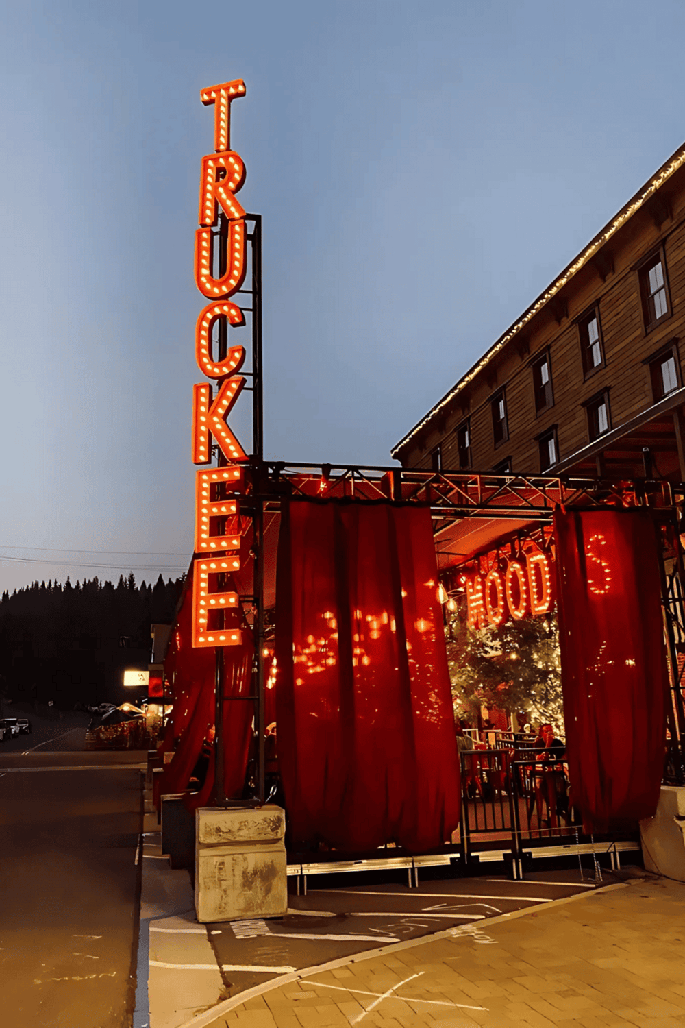 Bright red neon casino sign at dusk, attracting visitors to the vibrant entertainment venue.
