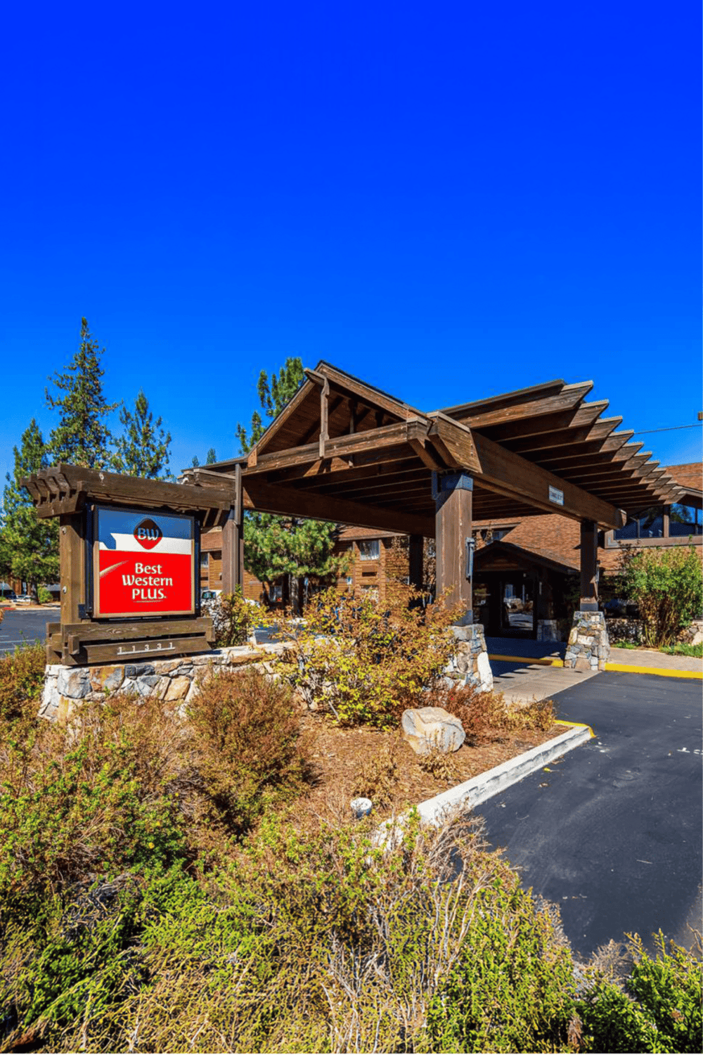 1. Entrance of Best Western Plus hotel with wooden architecture and landscape.