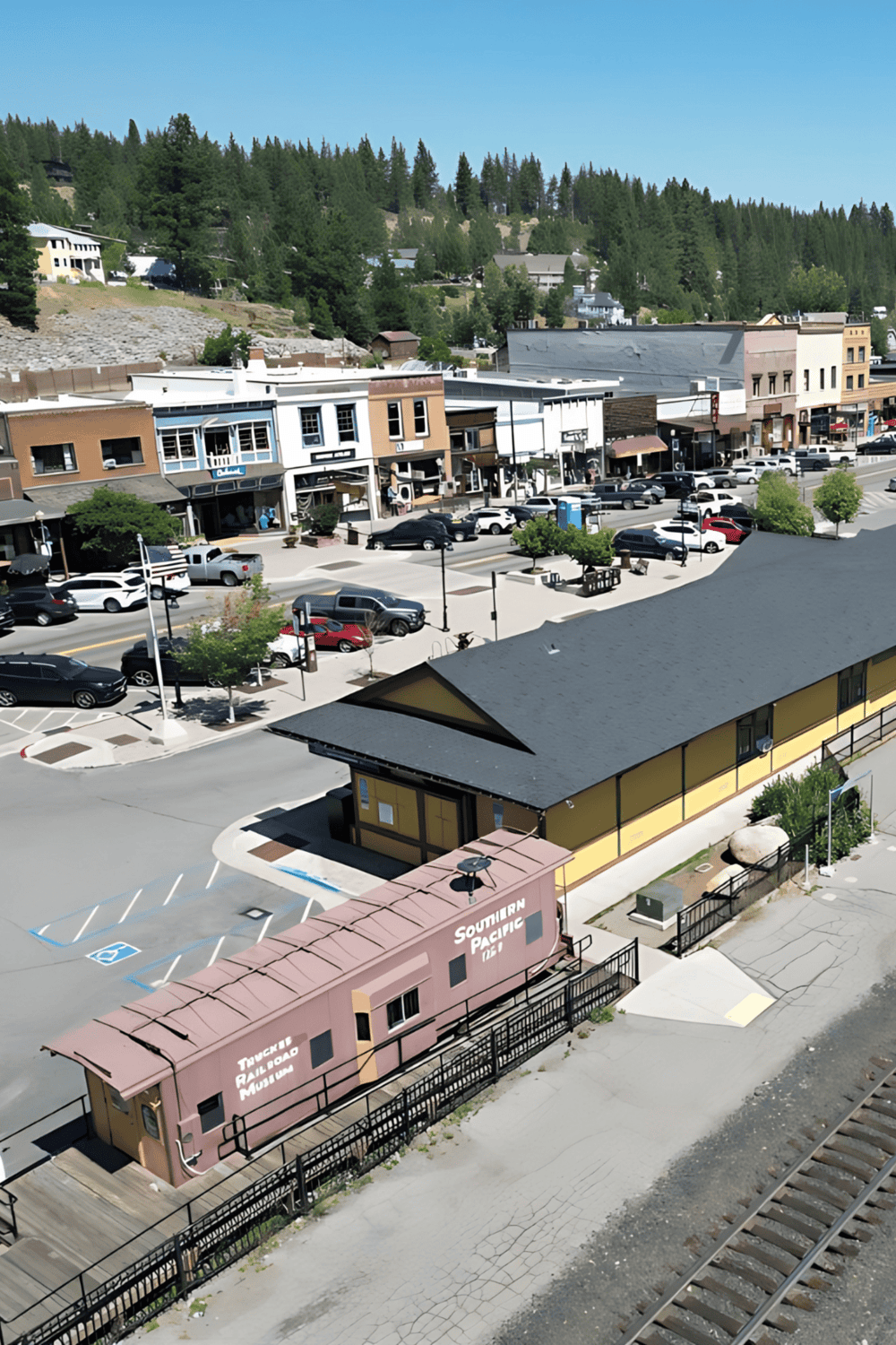 Charming downtown street scene with shops, parking, and mountain views in small-town America.