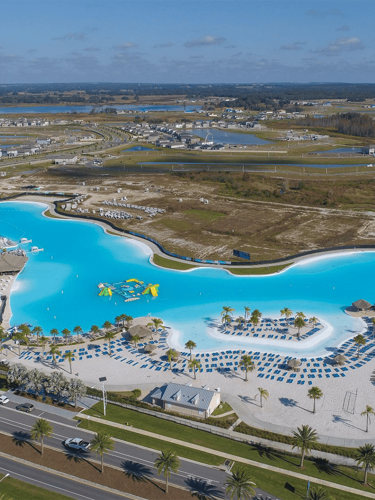 Bright resort water park with slides and palm trees, perfect family vacation destination.