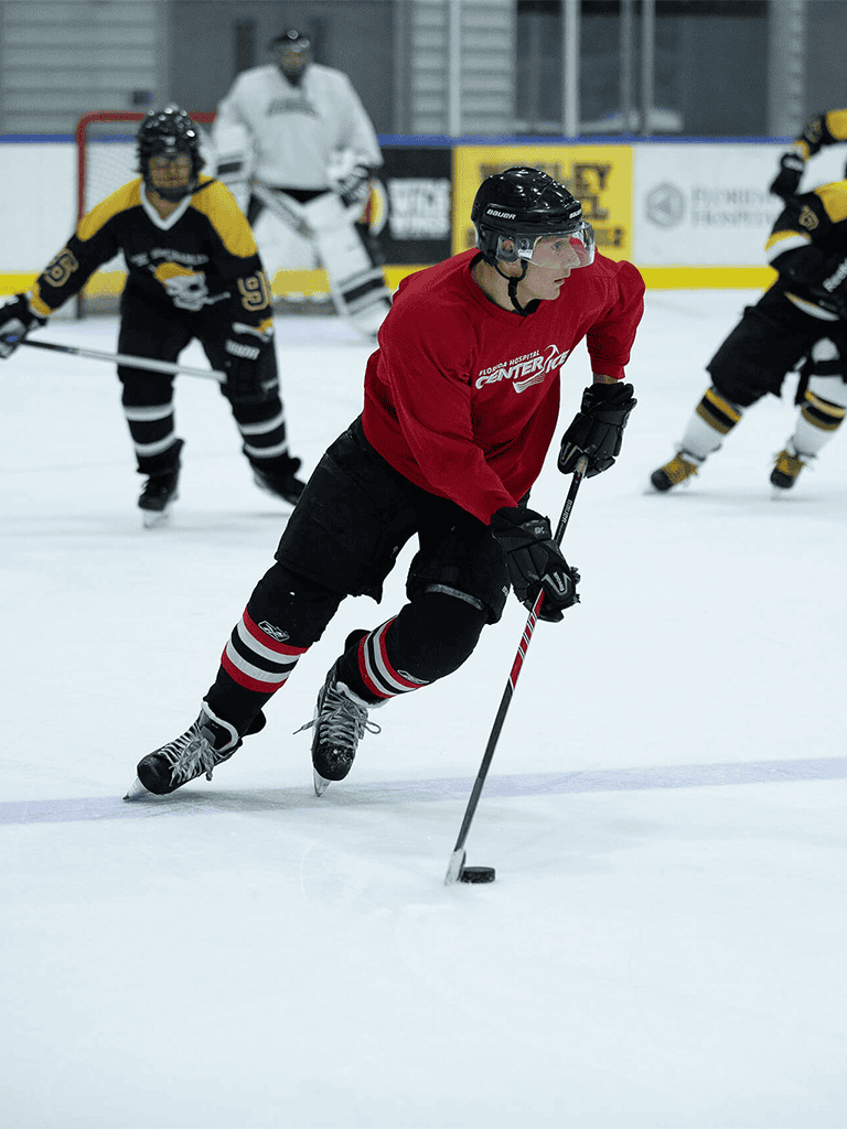 Fast-paced hockey game with players in action on the ice rink, showcasing skill and teamwork.