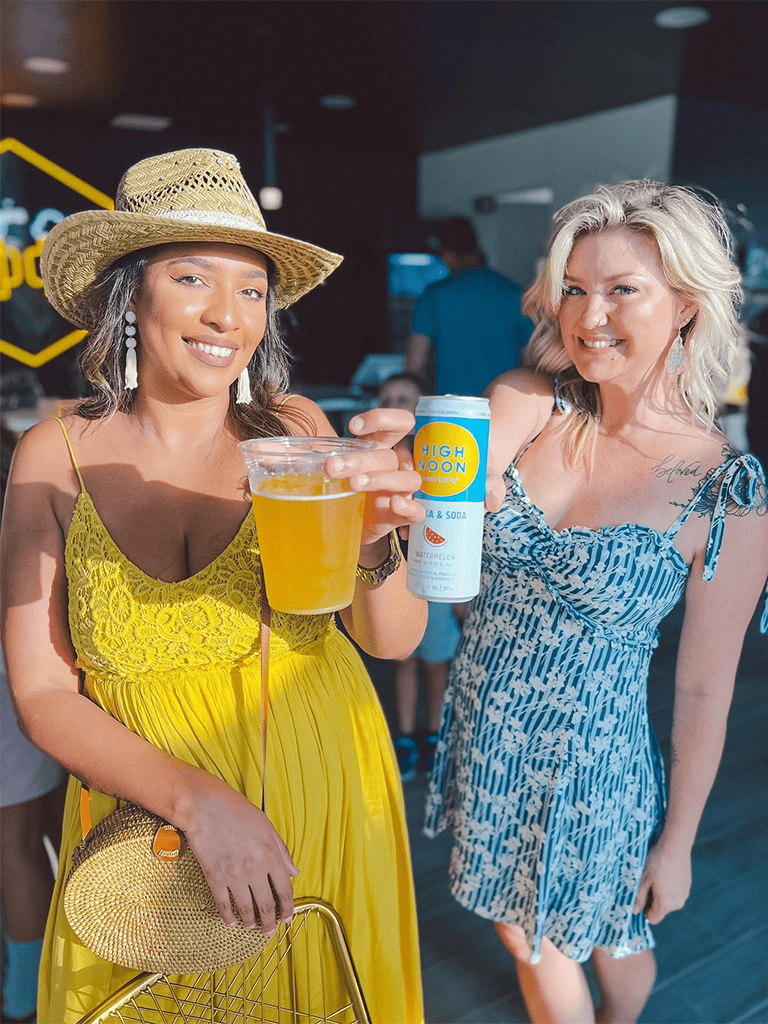 Bright women enjoying drinks at a social event, representing fun and celebration.