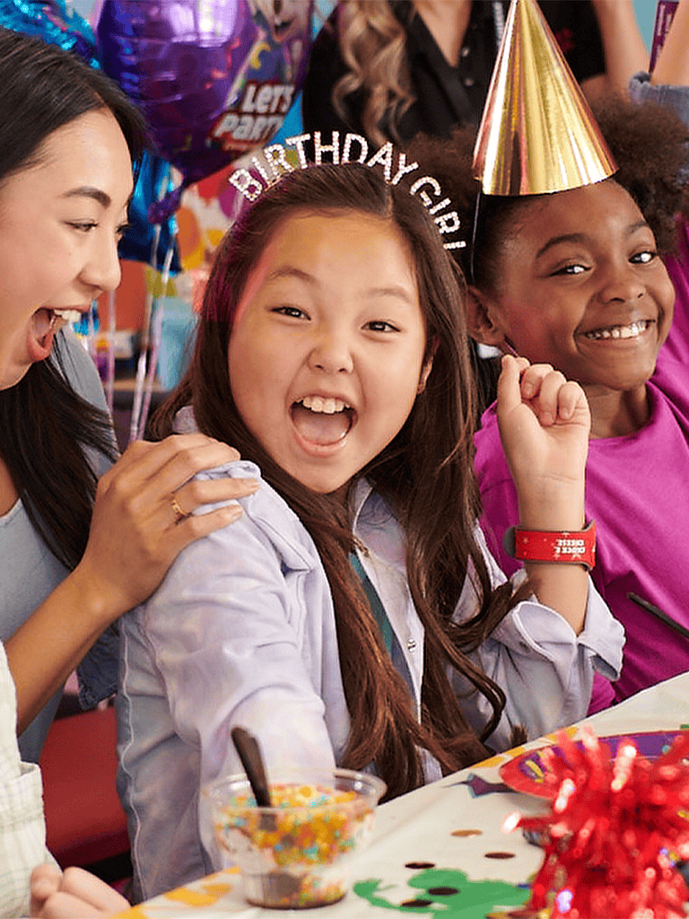 Vibrant birthday party celebration with kids, balloons, and colorful decorations.