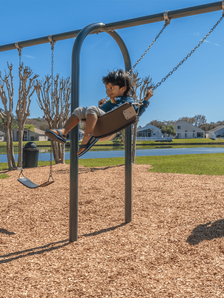 Child on playground swing enjoying outdoor recreation and family-friendly activities at QuestForDirections.