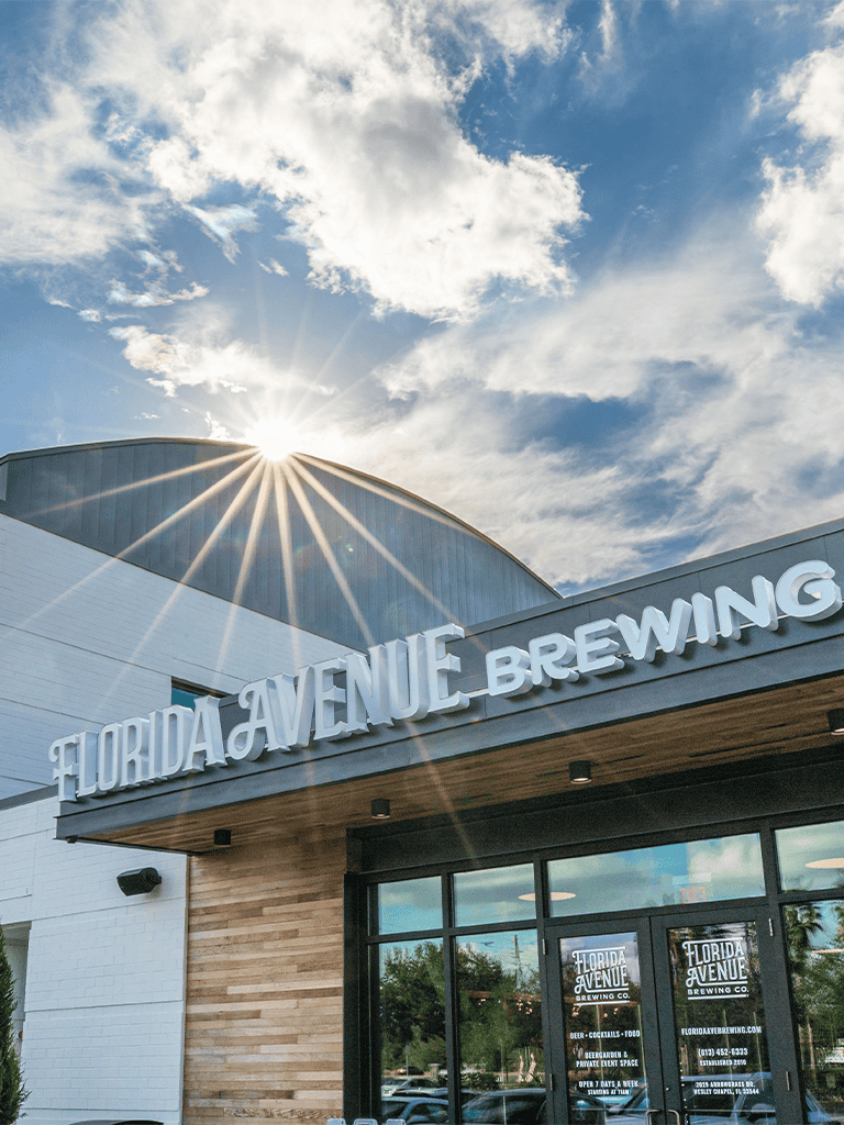 1. Modern Florida Avenue Brewing Co building with sun and sky in background.