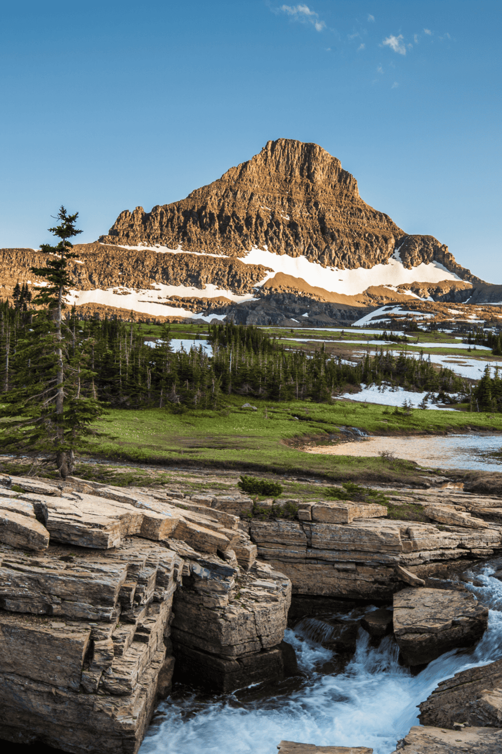 Vibrant mountain landscape with snow-capped peaks and lush greenery, perfect for adventure travel and hiking.
