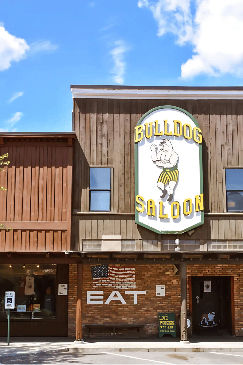 Bright wooden building with Bulldog Saloon sign and American flag artwork, inviting for bar and dining entertainment.