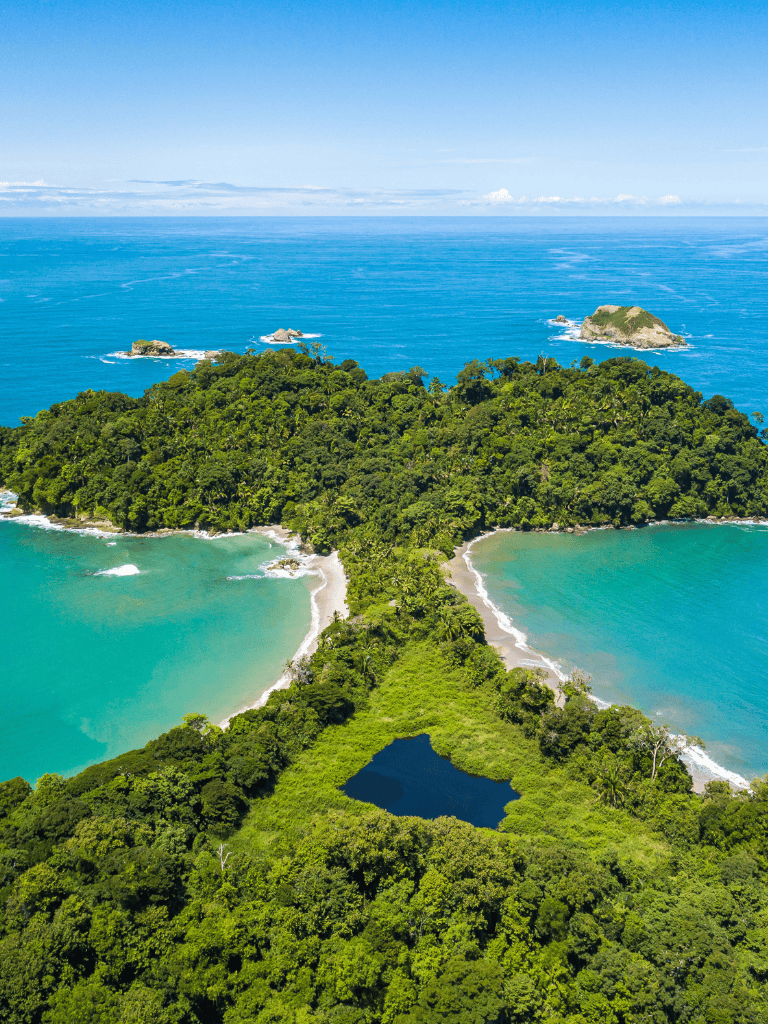 Vibrant tropical island with lush greenery, blue ocean, and small beaches, ideal for travel and adventure.