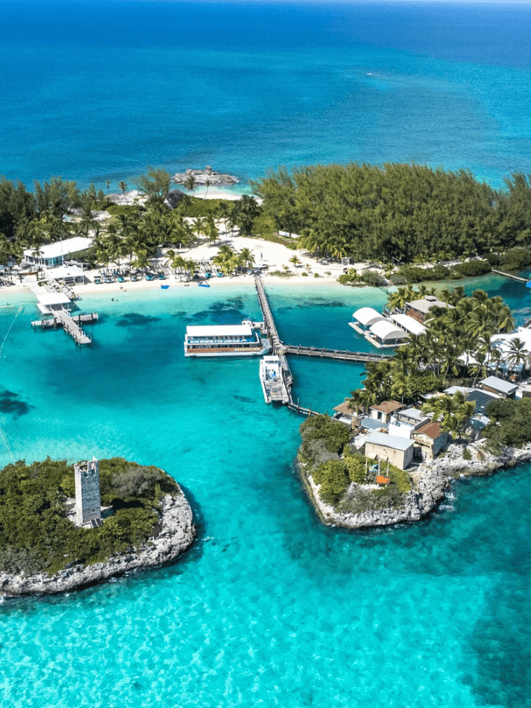 Idyllic tropical island with clear blue waters and marina resort, perfect for travel and vacation planning.