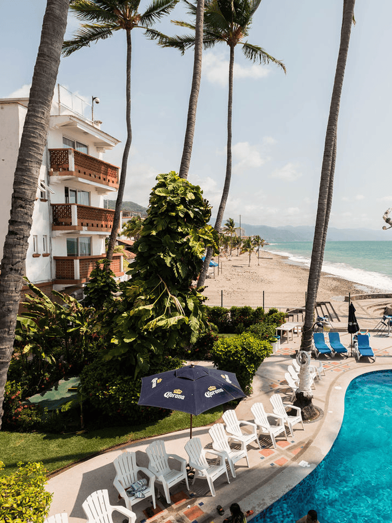Poolside hotel with palm trees and ocean view, vacation paradise at QuestForDirections.