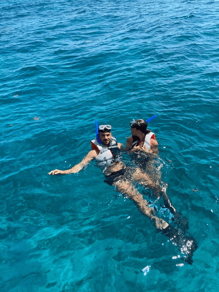 Snorkeling adventure with friends in clear blue ocean waters.
