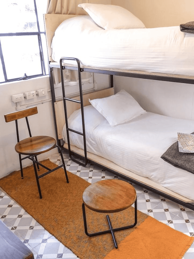 Comfy bunk bed with modern design in a cozy hostel or hotel room.