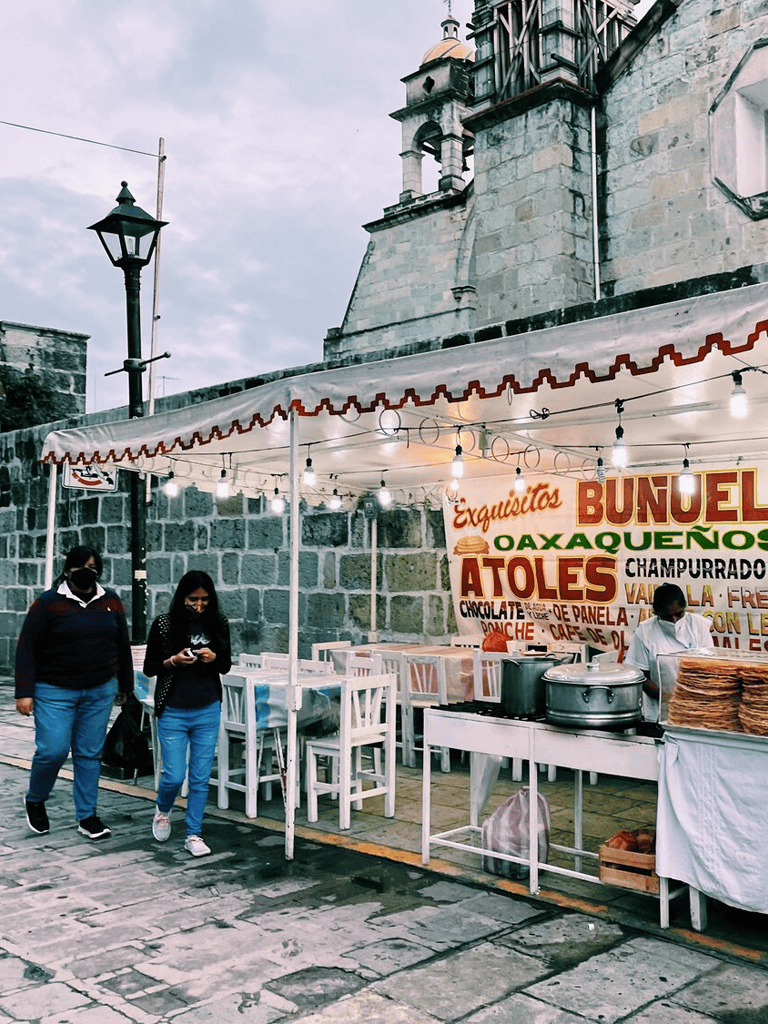 Cheese quesadillas and tacos stand at Mexico city street market, showcasing local street food vendors.