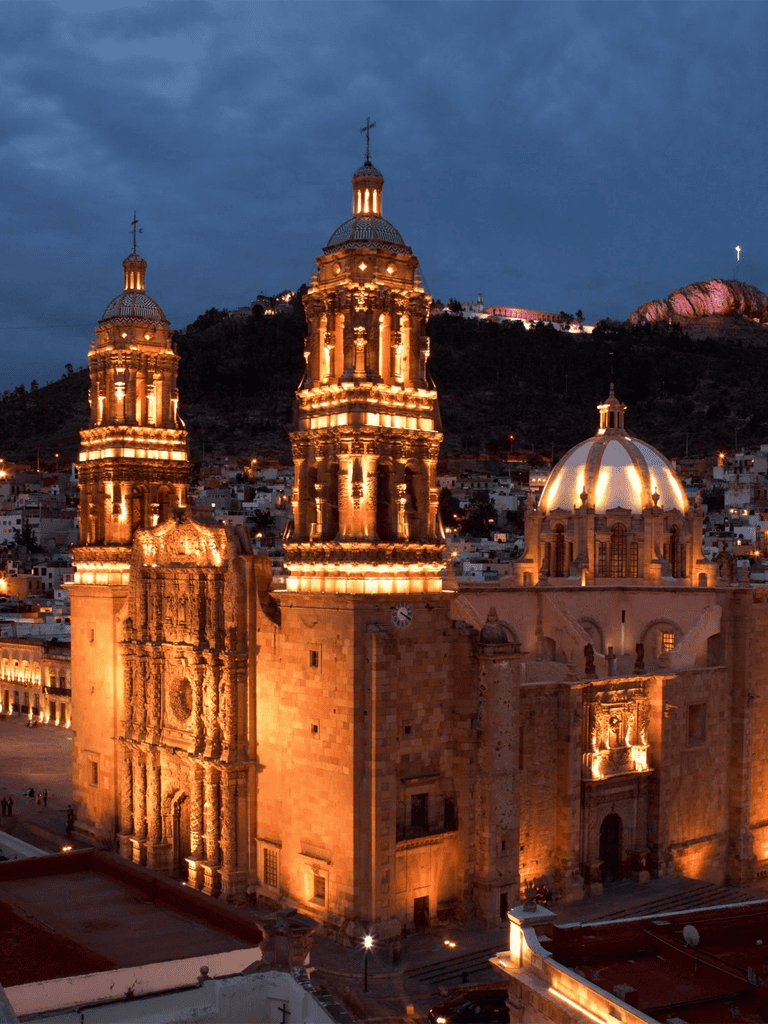 Historic Church illuminated at night in Mexico City, showcasing stunning architecture and city views.