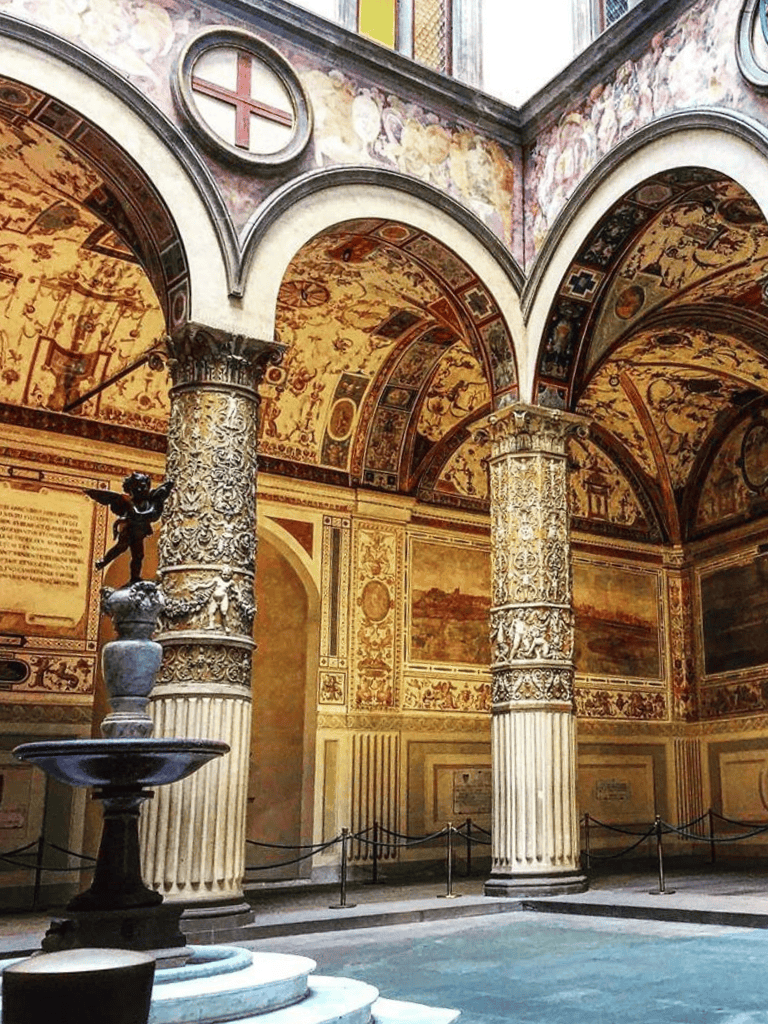 Ancient Roman-inspired interior with ornate columns and detailed frescoes, part of QuestForDirections exhibit.