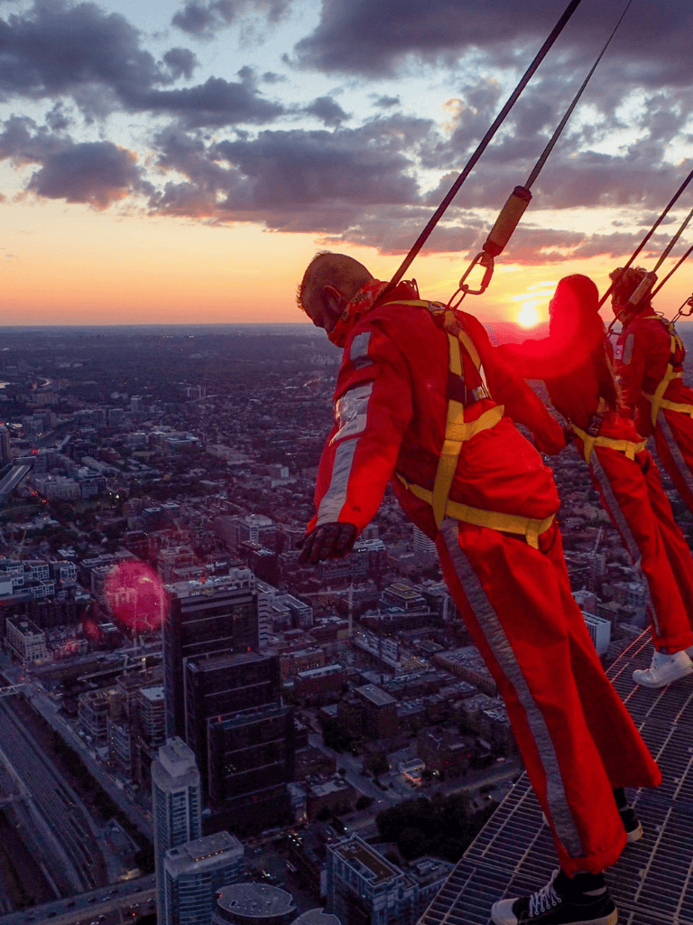 1. Urban skydiving team performing at sunset in a cityscape.