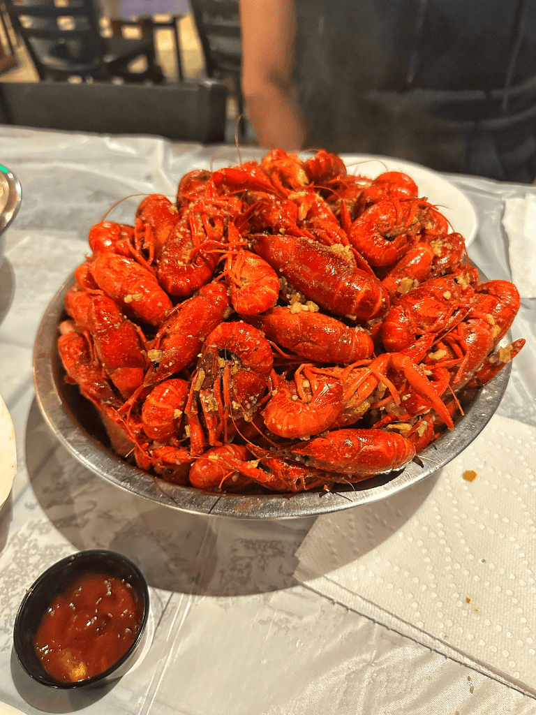 Succulent bowl of cooked crawfish with garlic and spices for seafood lovers.