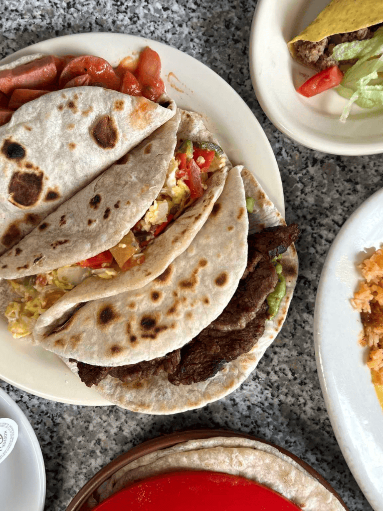 Fresh Mexican tacos with beef, vegetables, and tortillas at QuestForDirections.