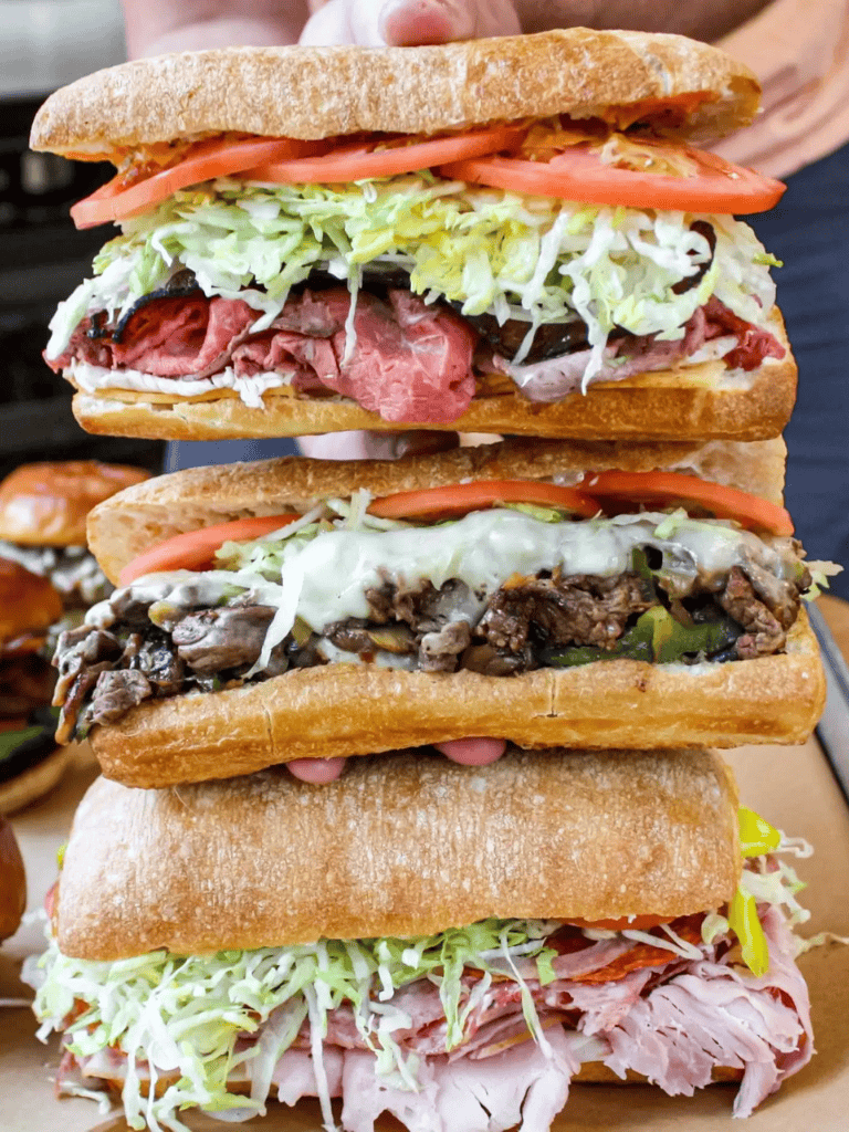 Juicy sandwiches with fresh vegetables, meats, and cheeses at QuestForDirections.