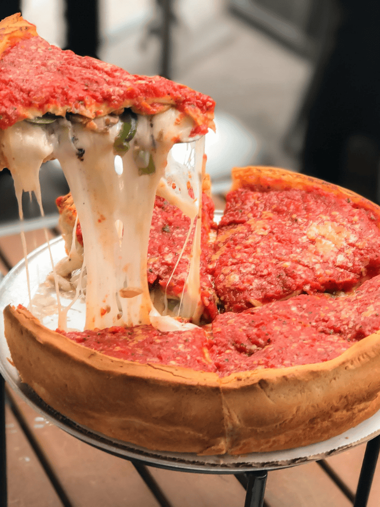 Cheesy stuffed pizza slice with melted cheese pull, classic Italian dish, delicious comfort food, cheesy pizza, savory toppings, pizza lovers favorite.
