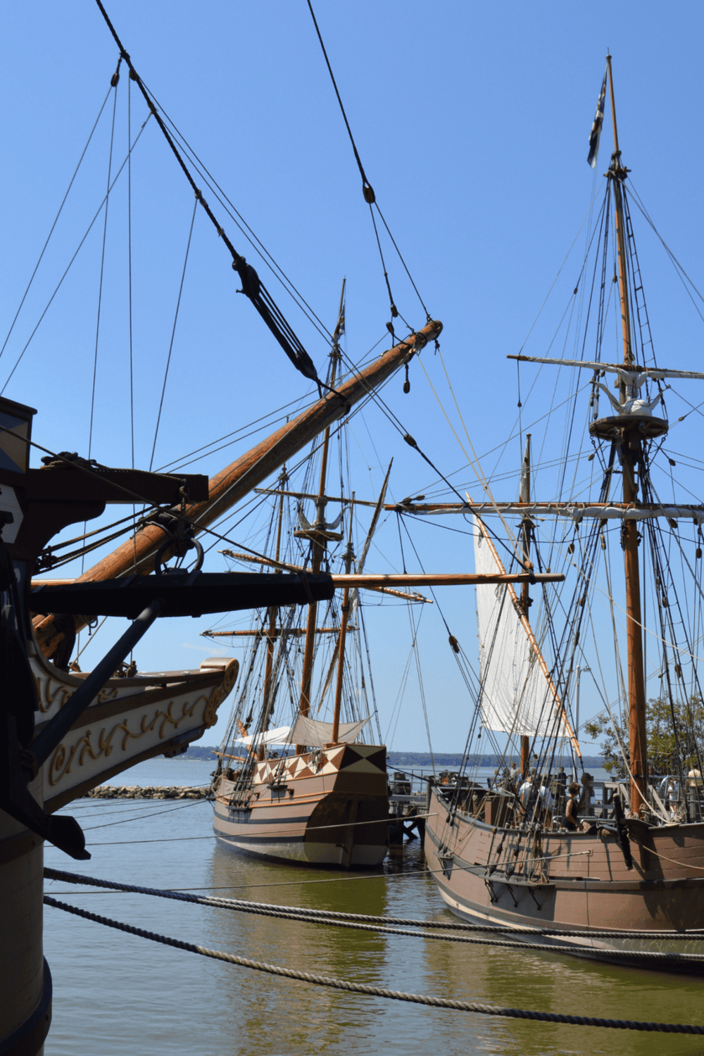 Vintage sailing ships docked at harbor with clear blue sky, epic maritime adventure, historic vessels, Nautical journeys, Quest for Directions.