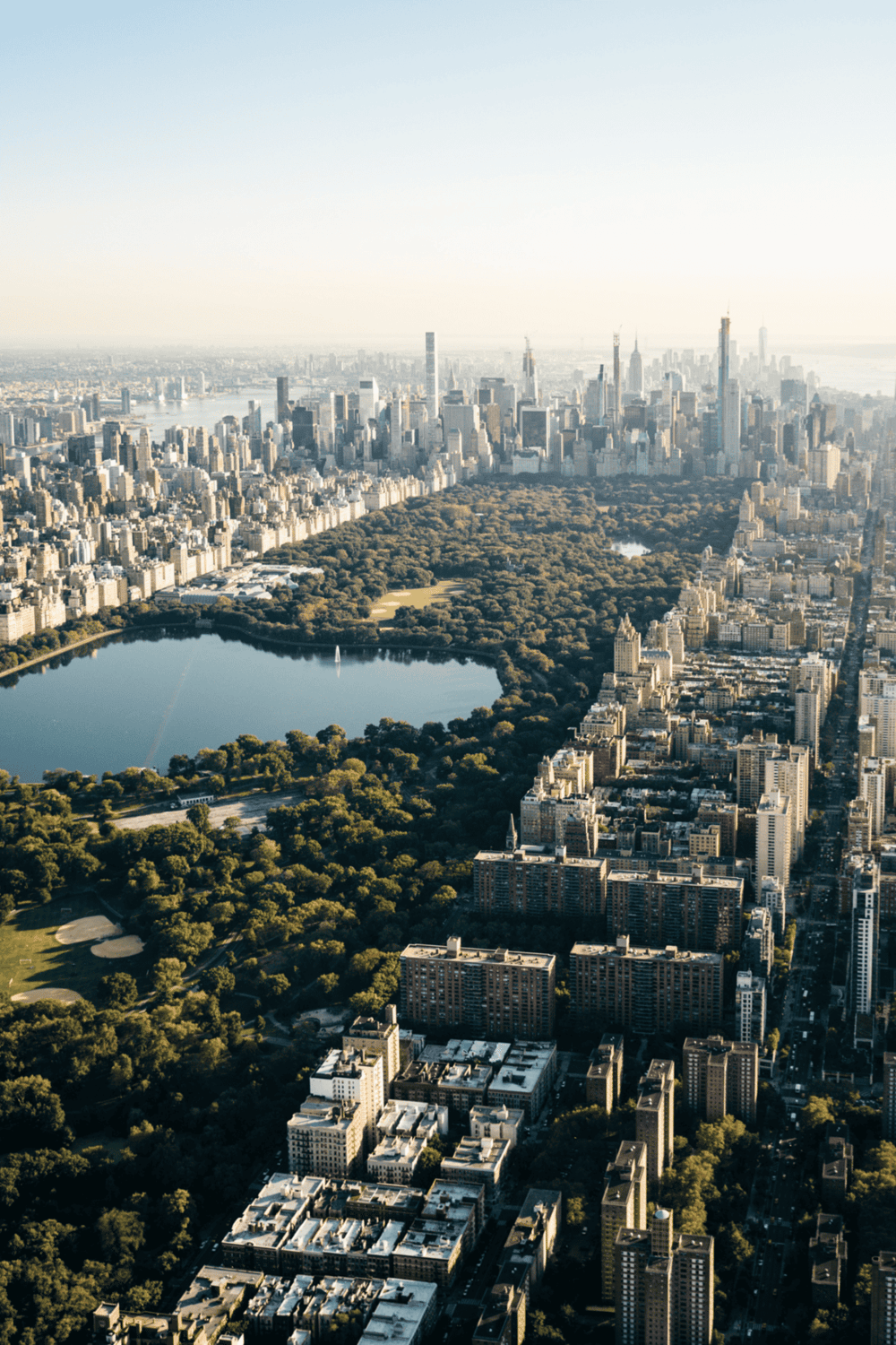 Serene view of Central Park in New York City from above, showcasing lush greenery amidst towering skyscrapers.
