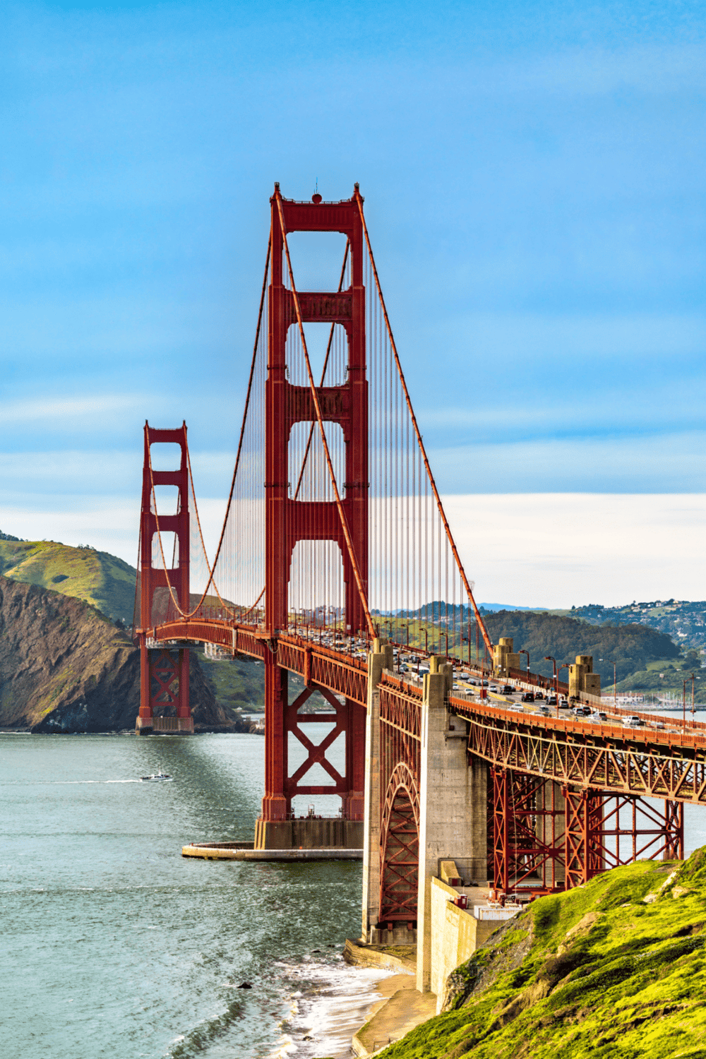 Golden Gate Bridge in San Francisco, iconic offshore suspension bridge with cars and scenic coastal views.