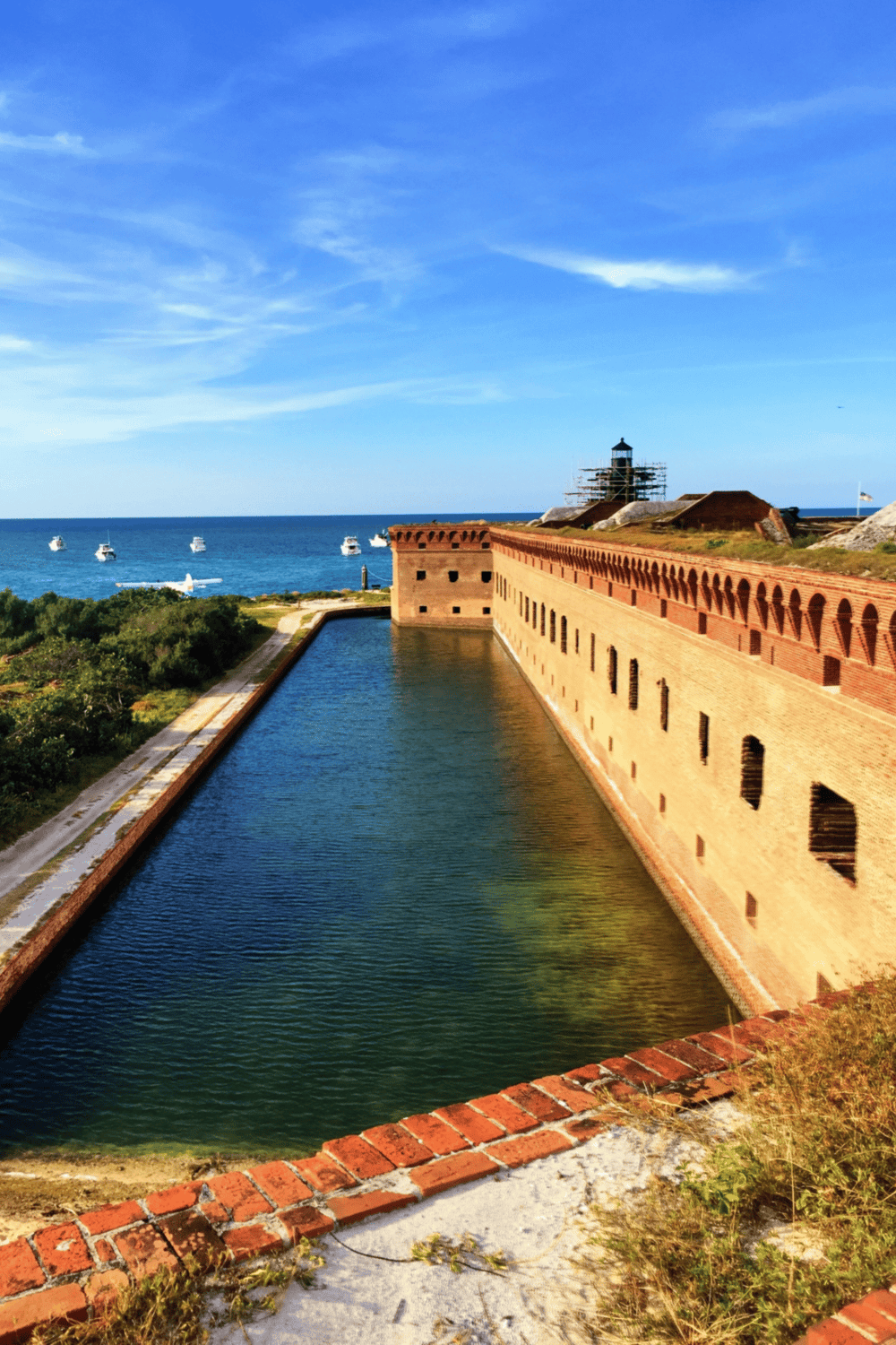 Sunset at historic Fort Zachary Taylor in Key West, with ocean views and boats.